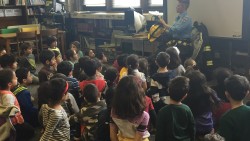 Fire fighter Jennifer Wenzel reads to out first graders